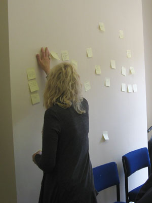 “Must Go To! (2012)”: handwritten post-it note installation on wall, dimensions variable 